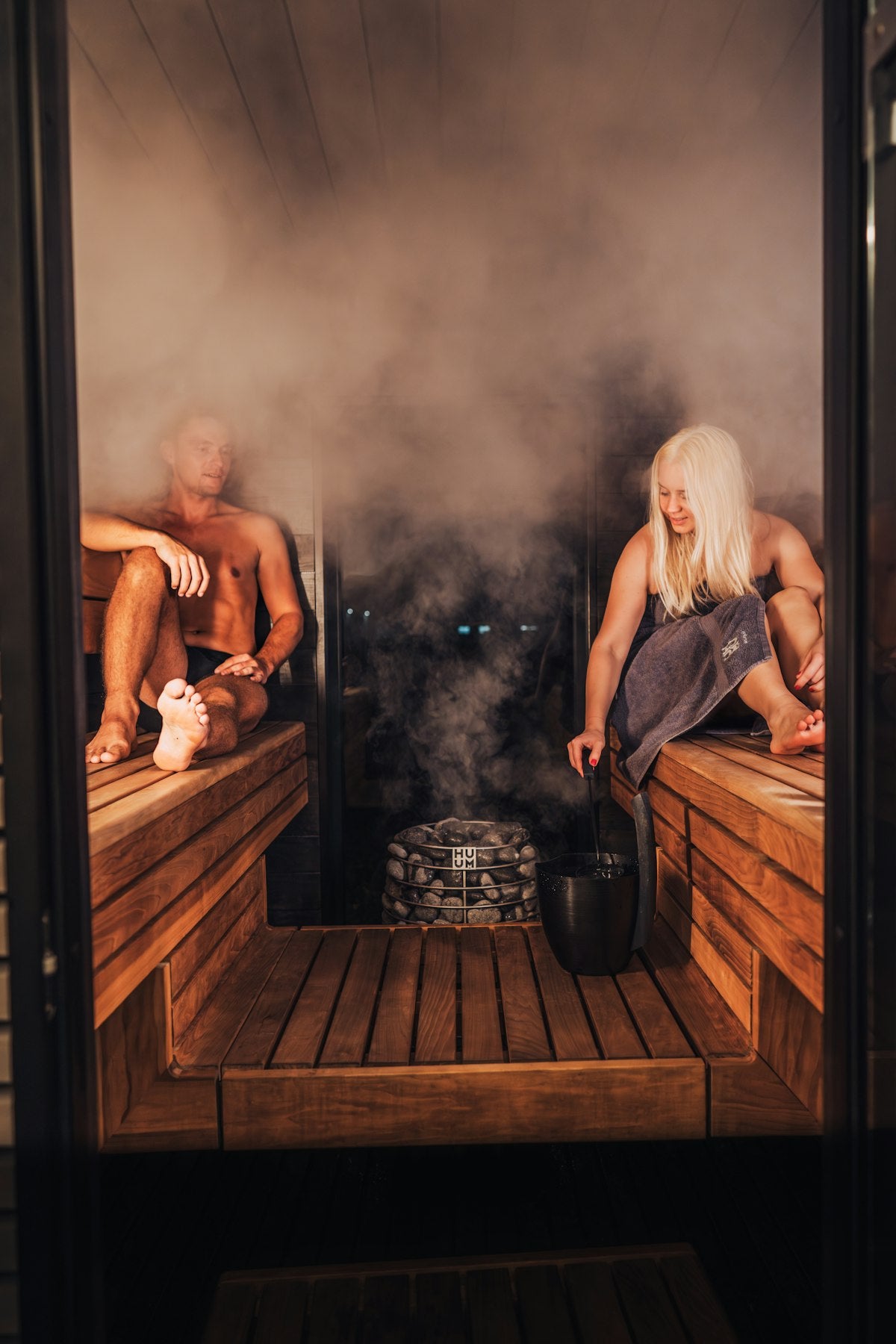People relaxing in a sauna during contrast therapy session