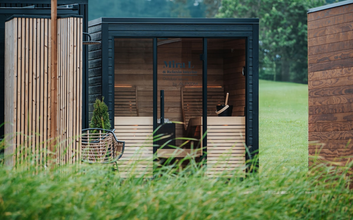 Modern wooden sauna cabins in a grassy field