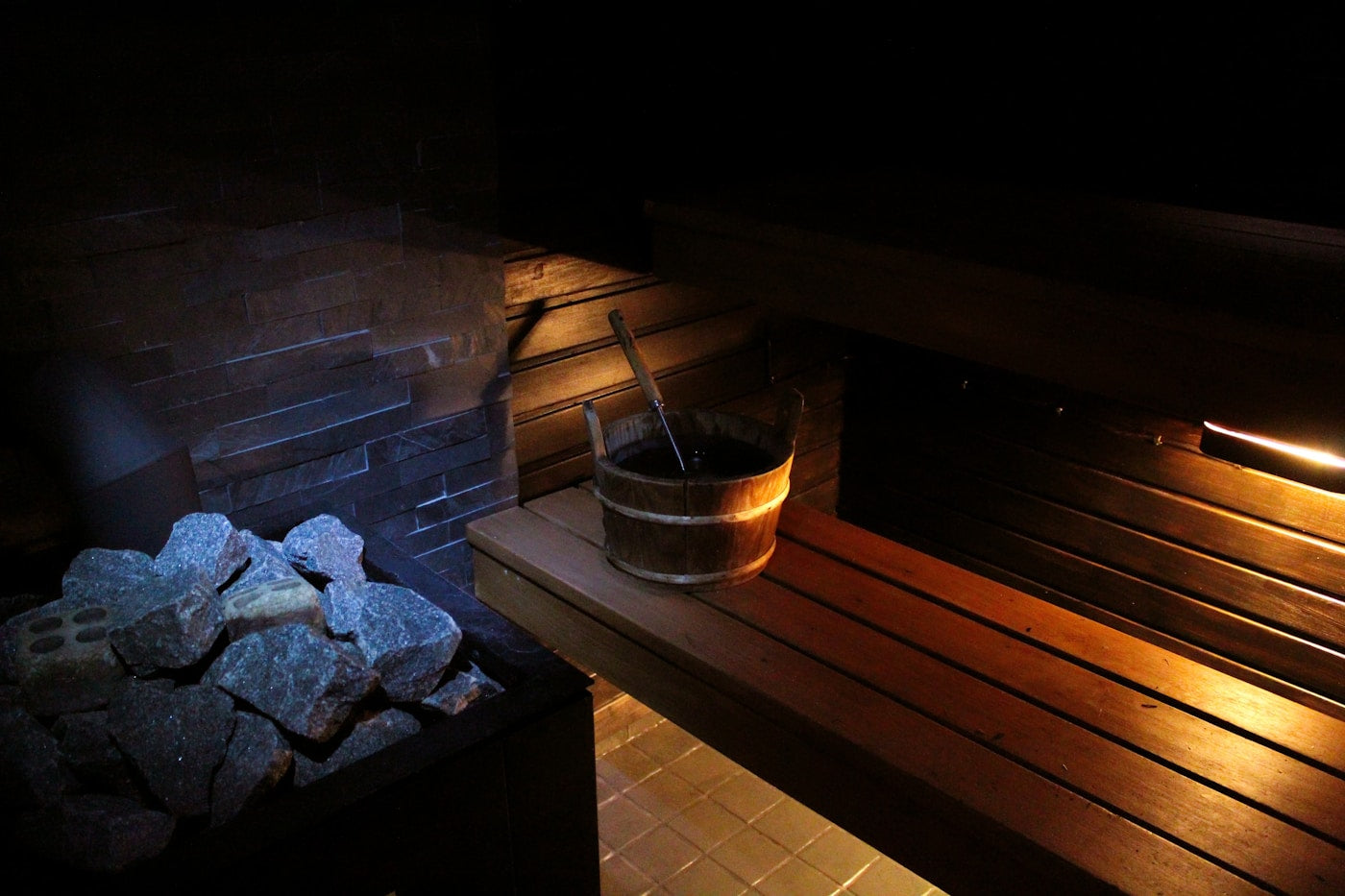 Sauna accessories with wooden bucket, ladle and stones